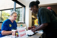 Kathy Nigro, left, a registered nurse at the Ingham County Health Department talks with Vennishia Smith, right, HIV/STD prevention coordinator for Ingham County Health Department, while volunteering at the health department, 5303 S. Cedar St. in Lansing, 