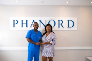 Dr. Kevin Phanord received the top 20 under 40 Haitian YoPros award from Nadia Alcide, Executive Director of the Haitian American Chamber of Commerce of Florida (HACCOF).