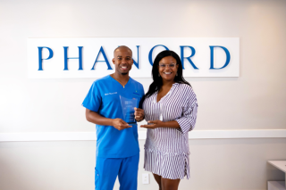 Dr. Kyle Phanord received the top 20 under 40 Haitian YoPros award from Nadia Alcide, Executive Director of the Haitian American Chamber of Commerce of Florida (HACCOF).