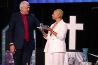 New COB President Bishop Tracy S. Malone receives the gavel from outgoing COB President Bishop Thomas Bickerton during the celebration of leadership on Tuesday, April 30, at the General Conference in Charlotte, N.C.