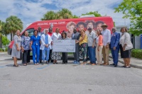 Photo Credit:  Ricardo Reyes, Sonshine Communications The Honorable Congresswoman Frederica S. Wilson (FL-24) (center) presents a $400,000 check to Jessie Trice Community Health System (JTCHS) for a Pediatric Medical Van and a Pediatric Dental Van to supp