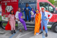 Photo Credit:  Ricardo Reyes, Sonshine Communications Members of the dental team from Jessie Trice Community Health System (JTCHS) and children dressed as dental superheroes pose together in the new Pediatric Dental Mobile Van.