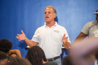 Pictured center: Buck Martinez, founder of Student ACES, holds student-athletes participating in the Florida vs. Georgia Future Stars 