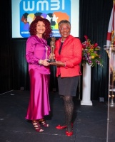 Ms. Anne McNeill (right) receiving the Trailblazing Women 2022 Award from Ms. Marie R. Gill